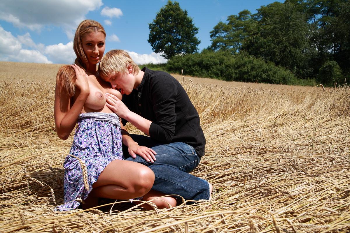 10P Young couple have sexual intercourse in a field of mature wheat