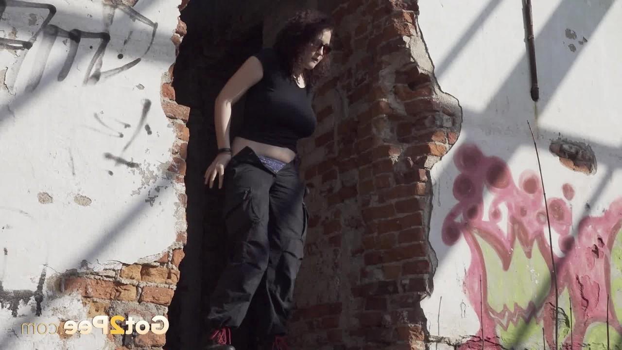 15P Brunette chick Alexa takes a piss after entering an abandoned building