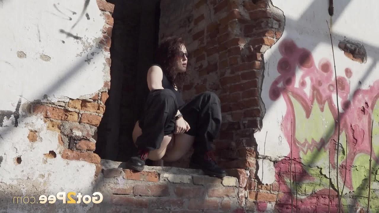 15P Brunette chick Alexa takes a piss after entering an abandoned building