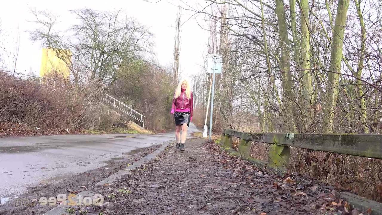 15P Blonde chick squats for a piss off the side of a wet road in boots