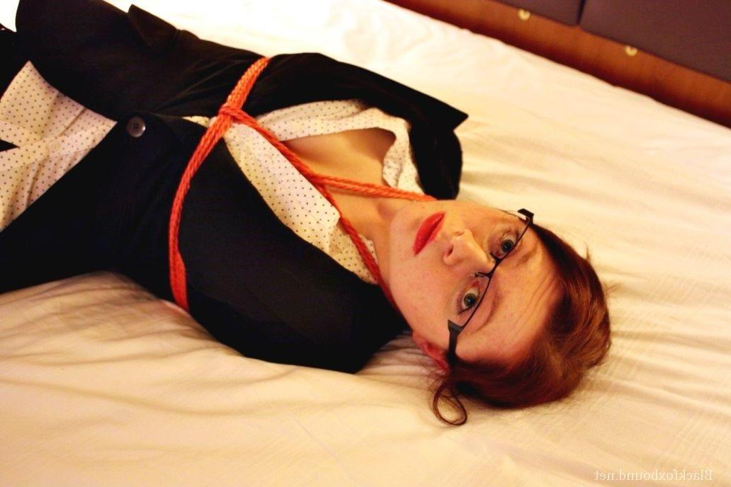 16P Natural redhead is tied up in her secretarial clothing and gagged as well