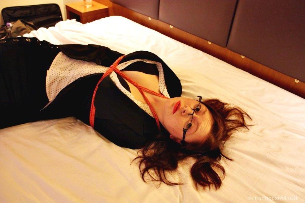 16P Natural redhead is tied up in her secretarial clothing and gagged as well