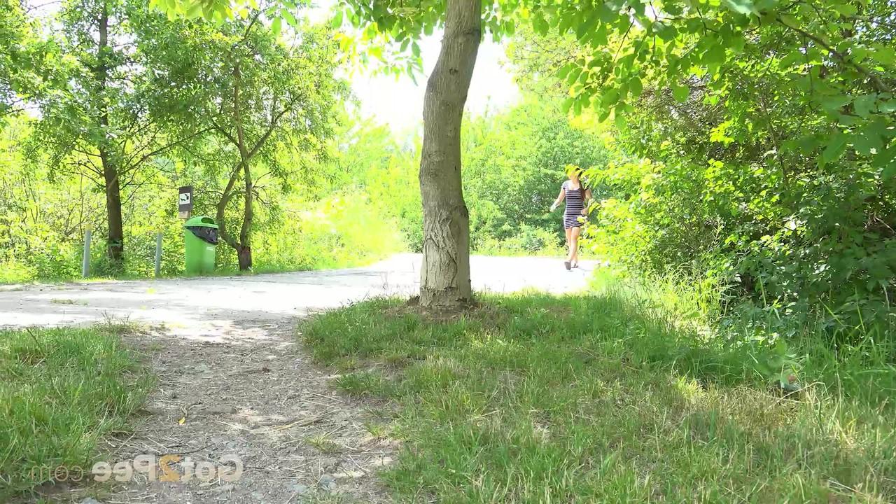 15P Natural redhead Morgan takes a piss under a tree alongside a walking path