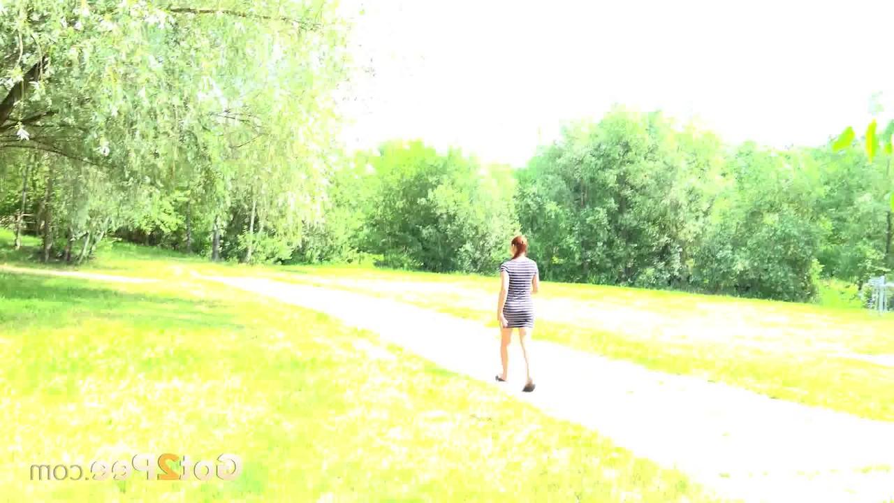 15P Natural redhead Morgan takes a piss under a tree alongside a walking path