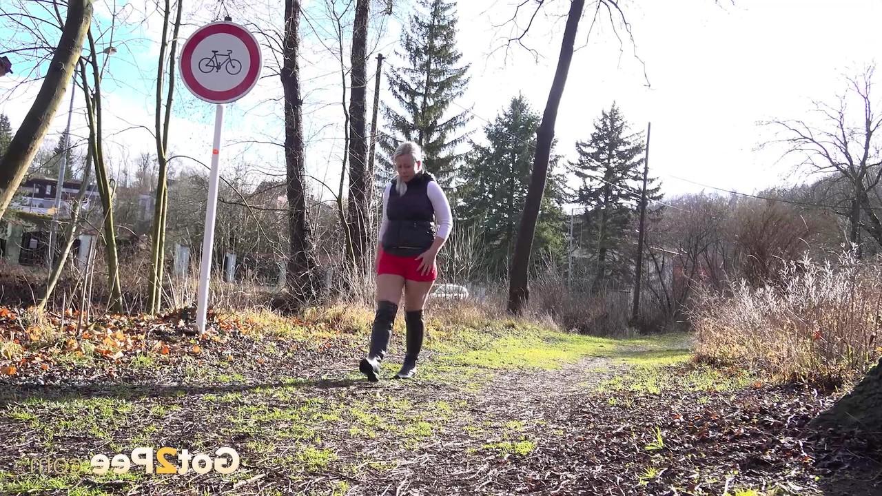 15P Chubby blonde Licky Lex takes a piss on a path in black boots