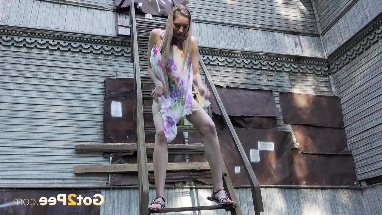 15P Solo girl climbs a set of outdoor stairs before taking a piss
