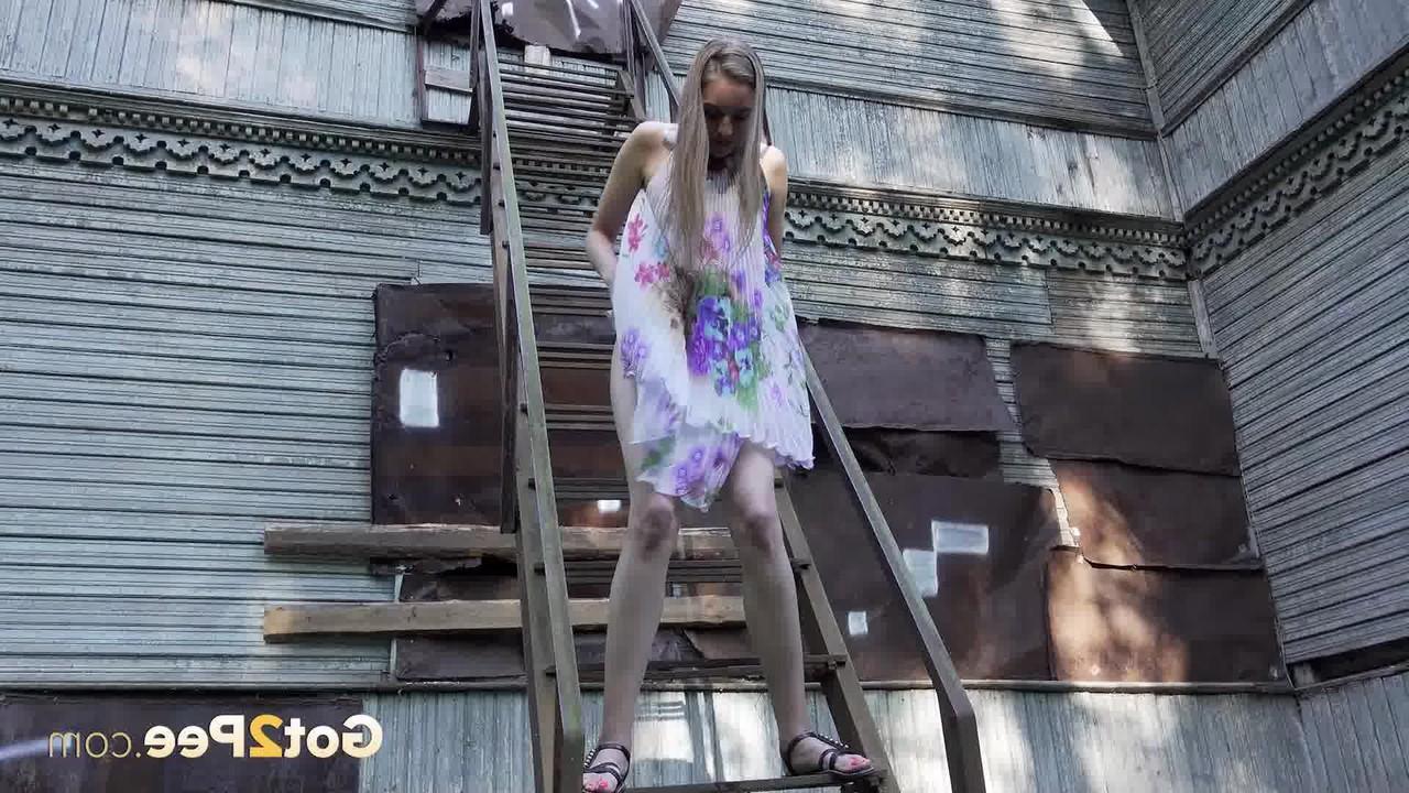 15P Solo girl climbs a set of outdoor stairs before taking a piss