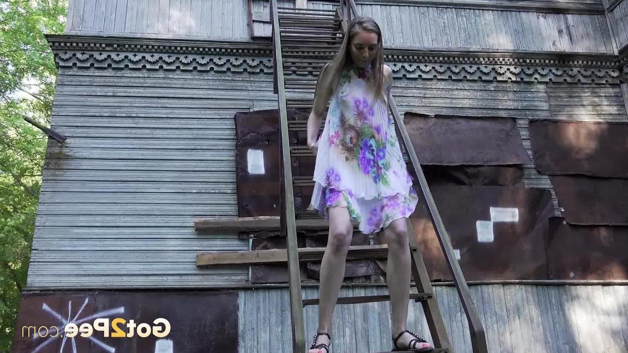 15P Solo girl climbs a set of outdoor stairs before taking a piss