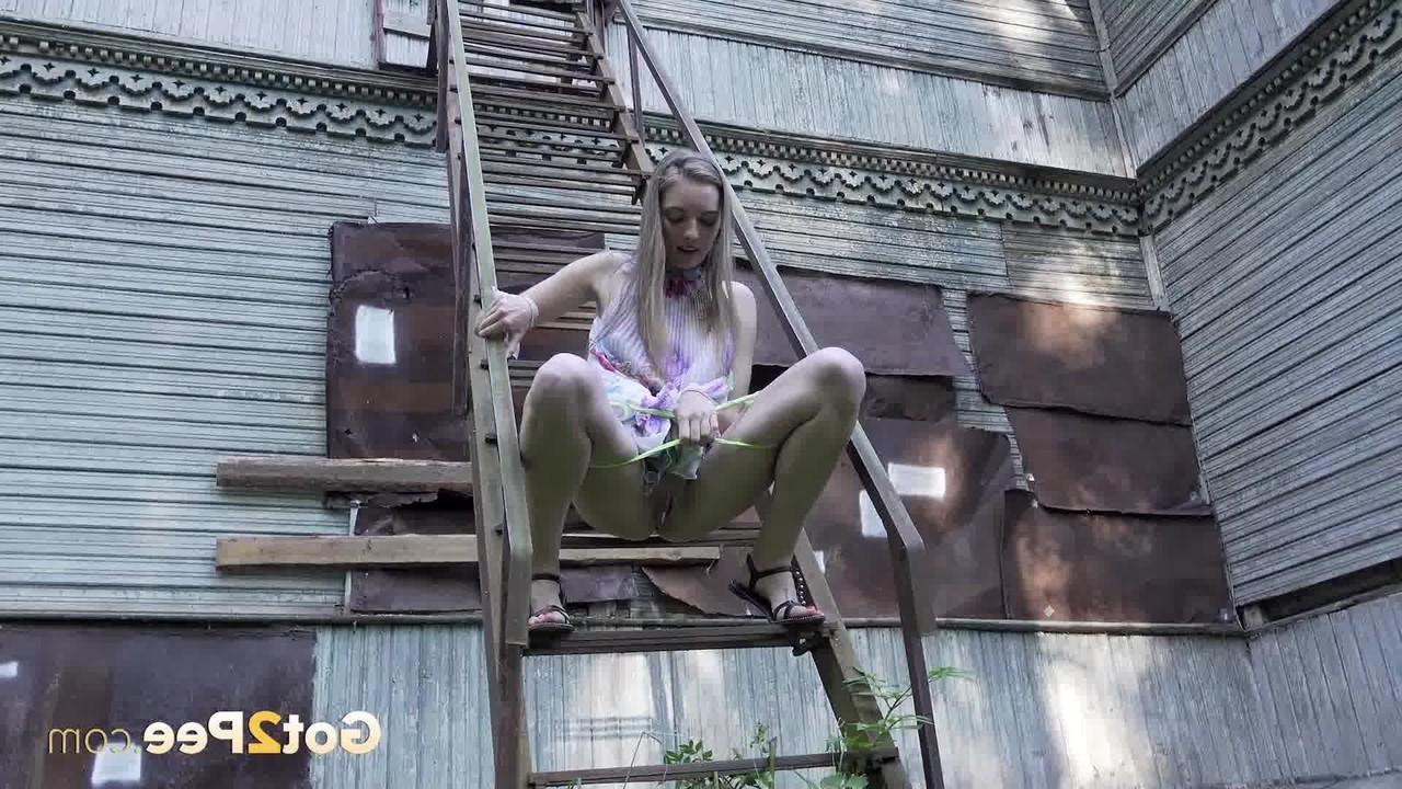 15P Solo girl climbs a set of outdoor stairs before taking a piss