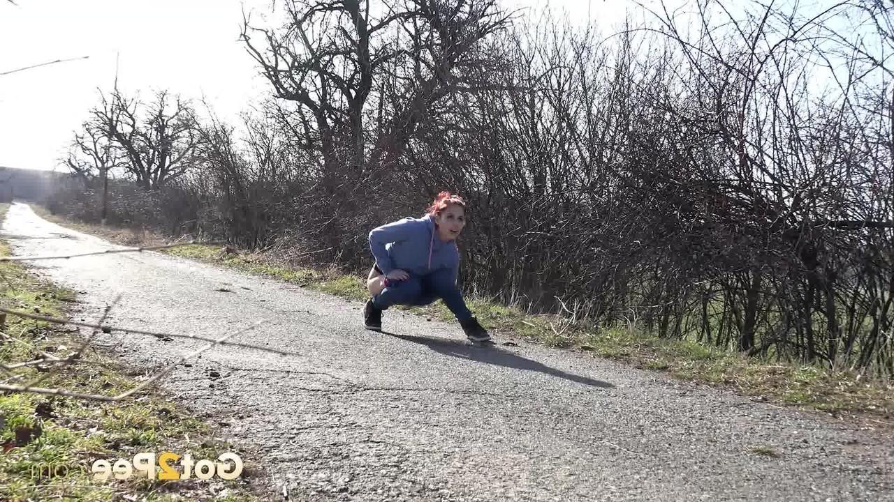 15P Natural redhead Antonia Sainz takes a pee on a road in the countryside