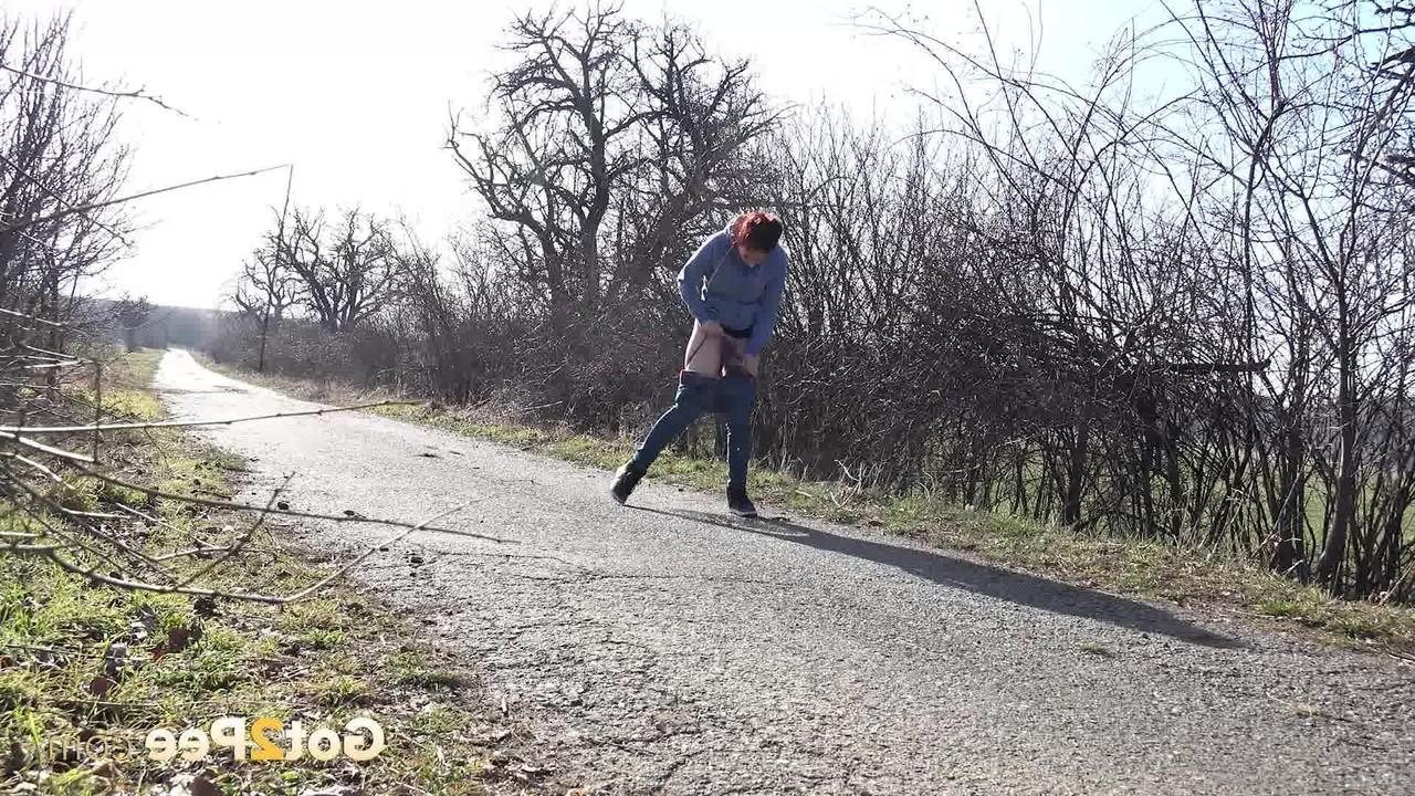 15P Natural redhead Antonia Sainz takes a pee on a road in the countryside