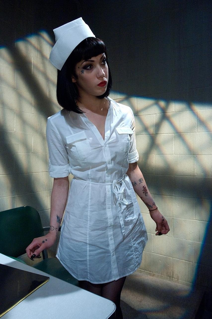 20P Slutty dark haired nurse shows her amazing ass and big tits at the hospital