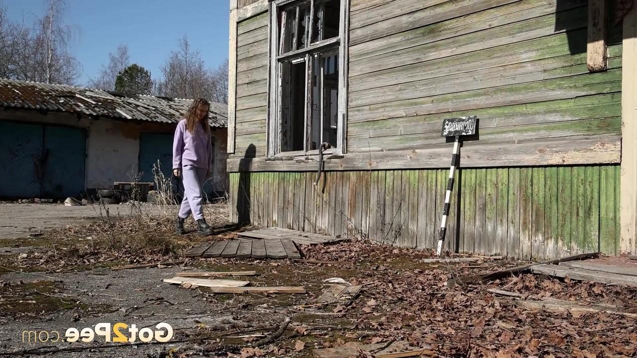 15P Nikky B takes a badly needed pee on the back porch of a rustic dwelling