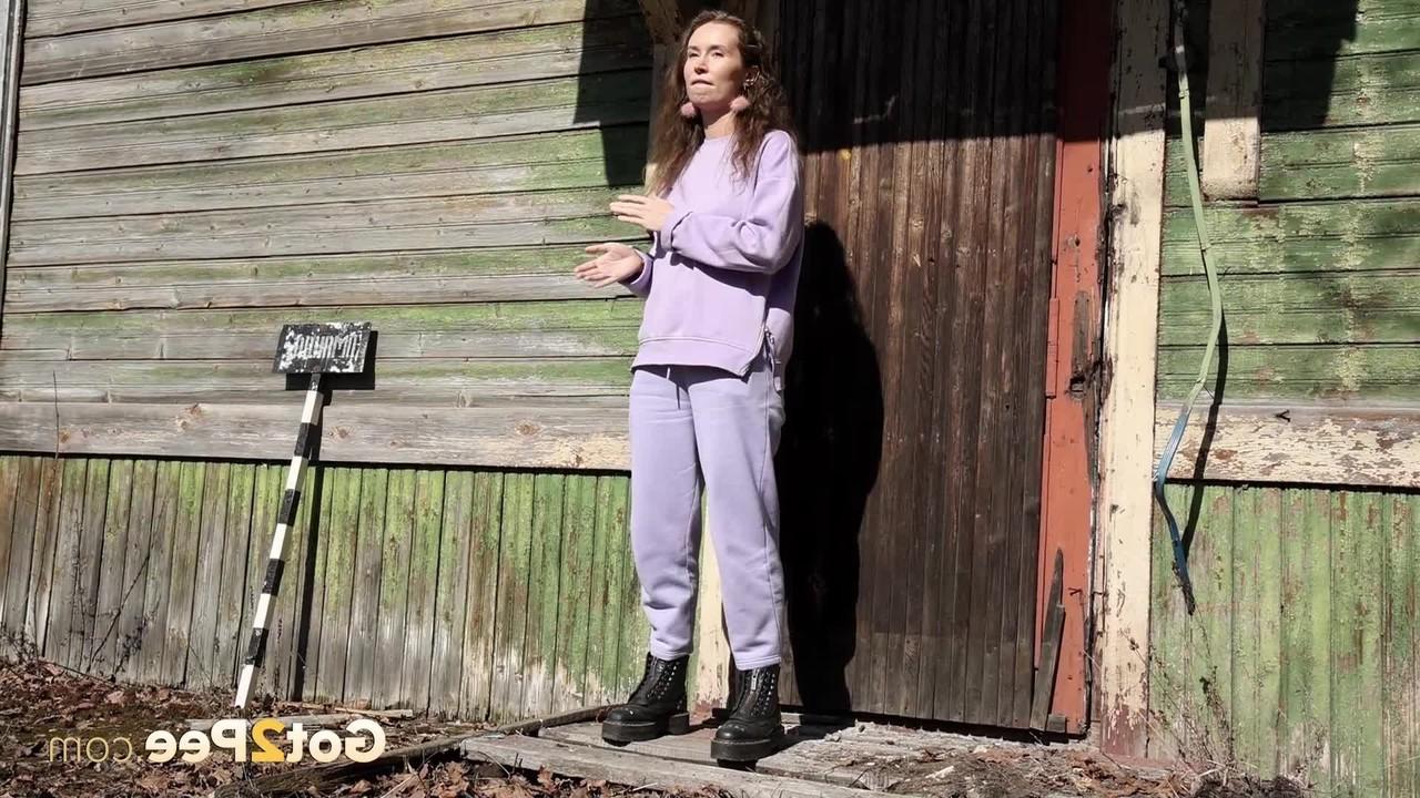 15P Nikky B takes a badly needed pee on the back porch of a rustic dwelling