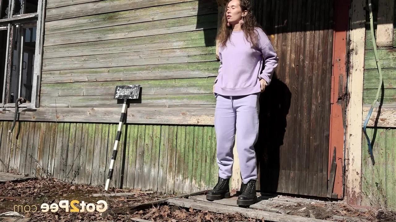 15P Nikky B takes a badly needed pee on the back porch of a rustic dwelling
