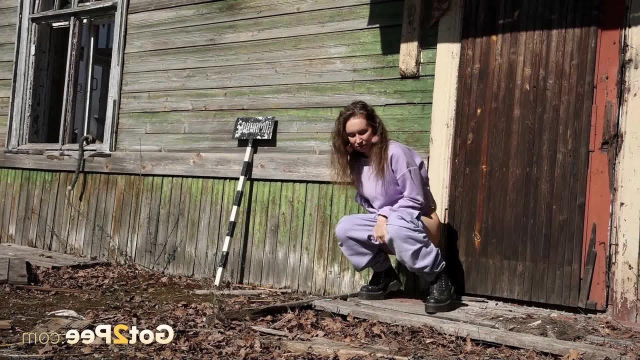 15P Nikky B takes a badly needed pee on the back porch of a rustic dwelling