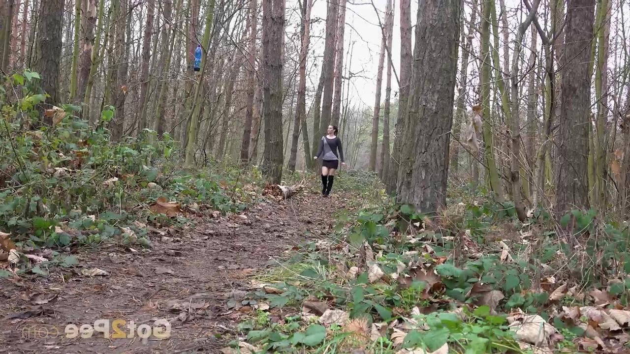 15P Caucasian female Victoria Daniels pees in a forest while wearing OTK boots