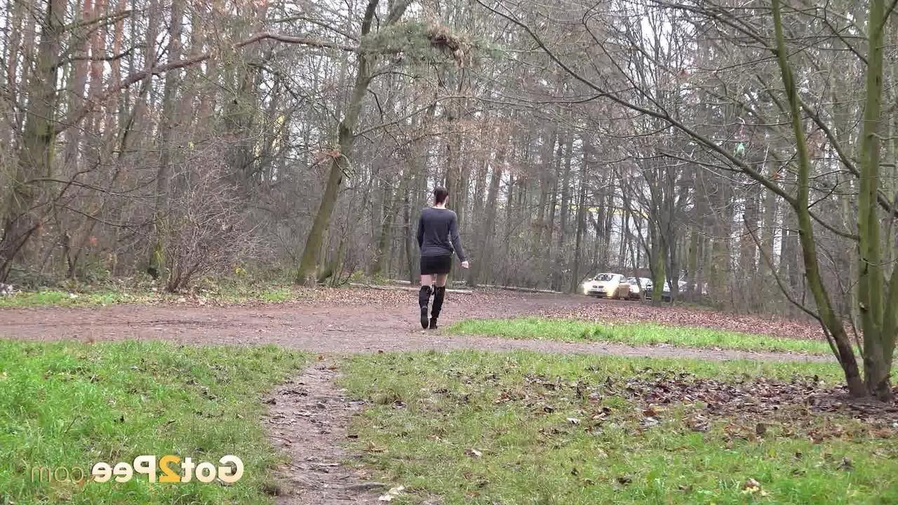 15P Caucasian female Victoria Daniels pees in a forest while wearing OTK boots