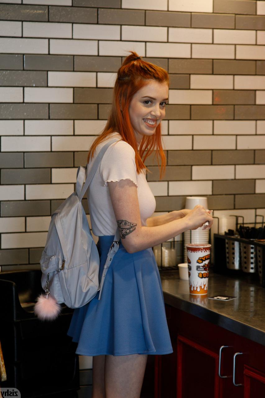 12P Pretty redhead Wanda Ablee flashes an arousing upskirt in panties