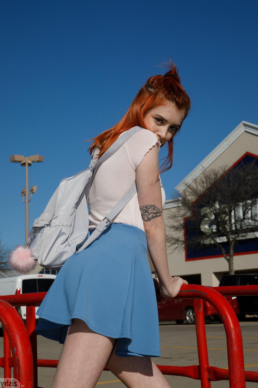 12P Pretty redhead Wanda Ablee flashes an arousing upskirt in panties