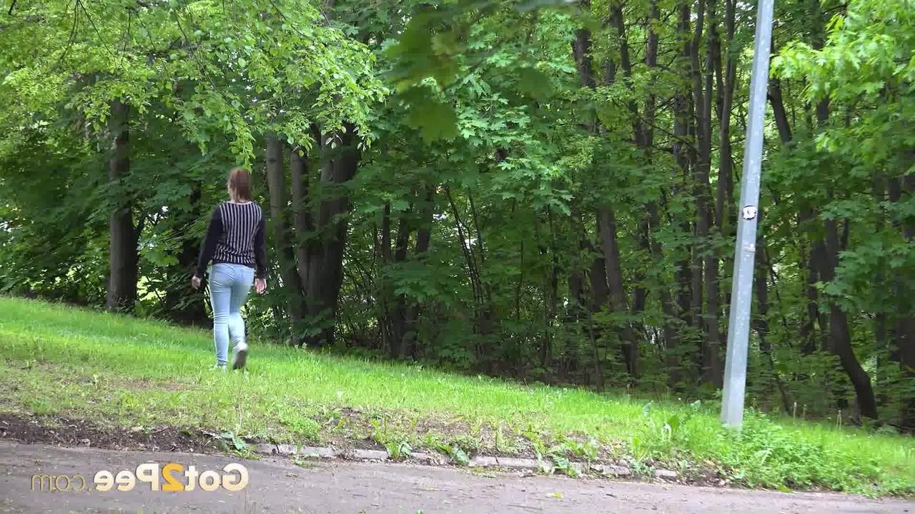 15P Caucasian girl Naomi Bennet ducks behind a concrete wall for a much needed pee
