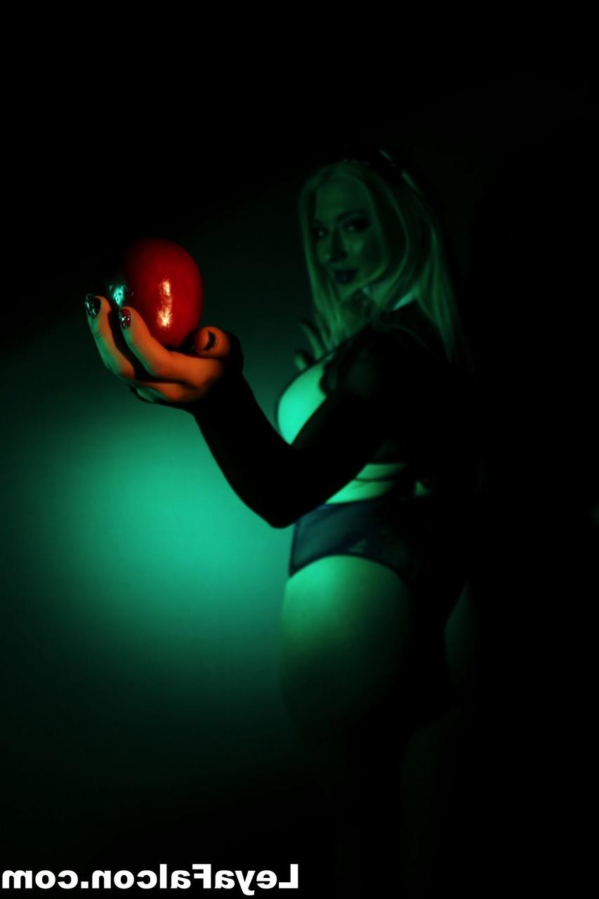 12P Blonde MILF Leya Falcon holds an apple while wearing sheer lingerie