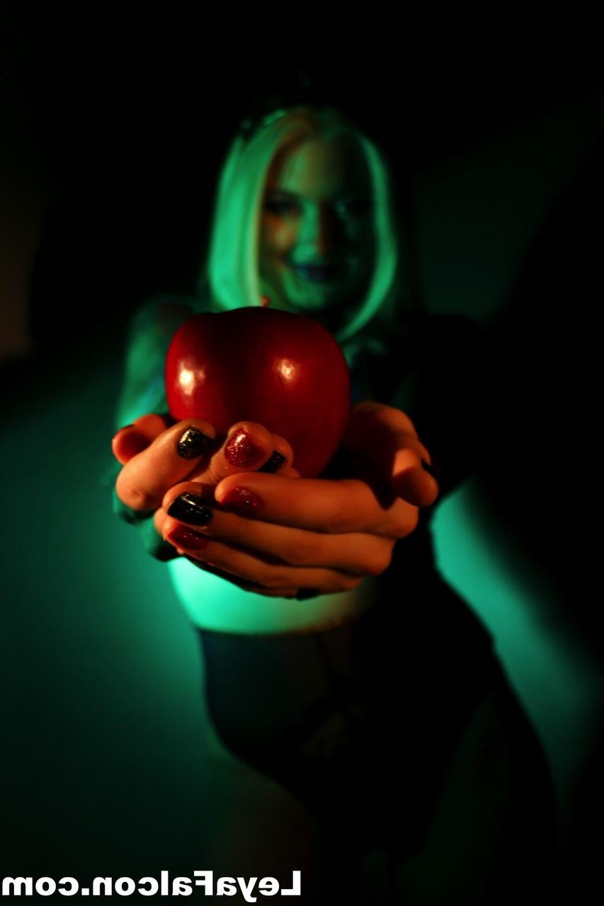 12P Blonde MILF Leya Falcon holds an apple while wearing sheer lingerie