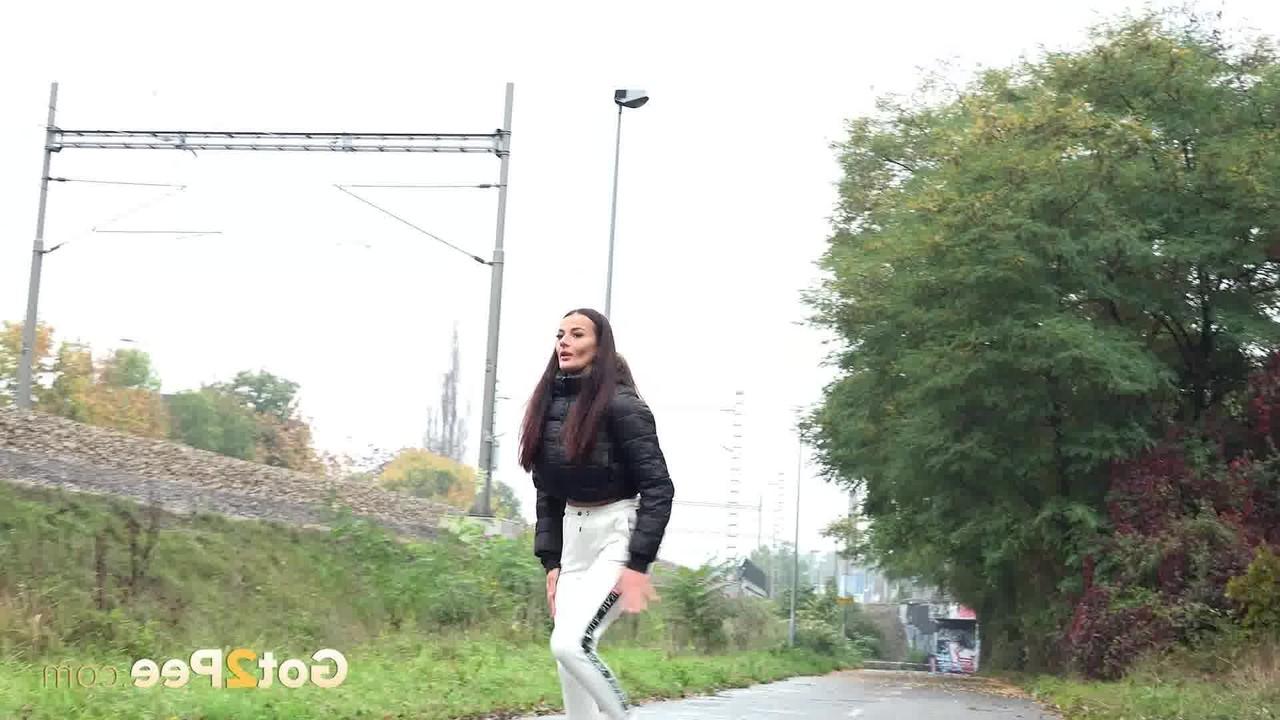 14P Maddi Black pulls down her pants before pissing in a puddle
