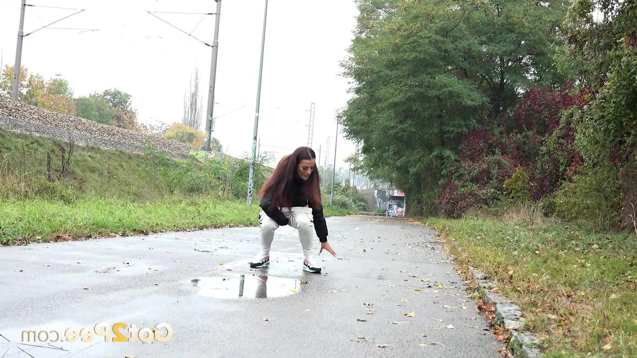 14P Maddi Black pulls down her pants before pissing in a puddle