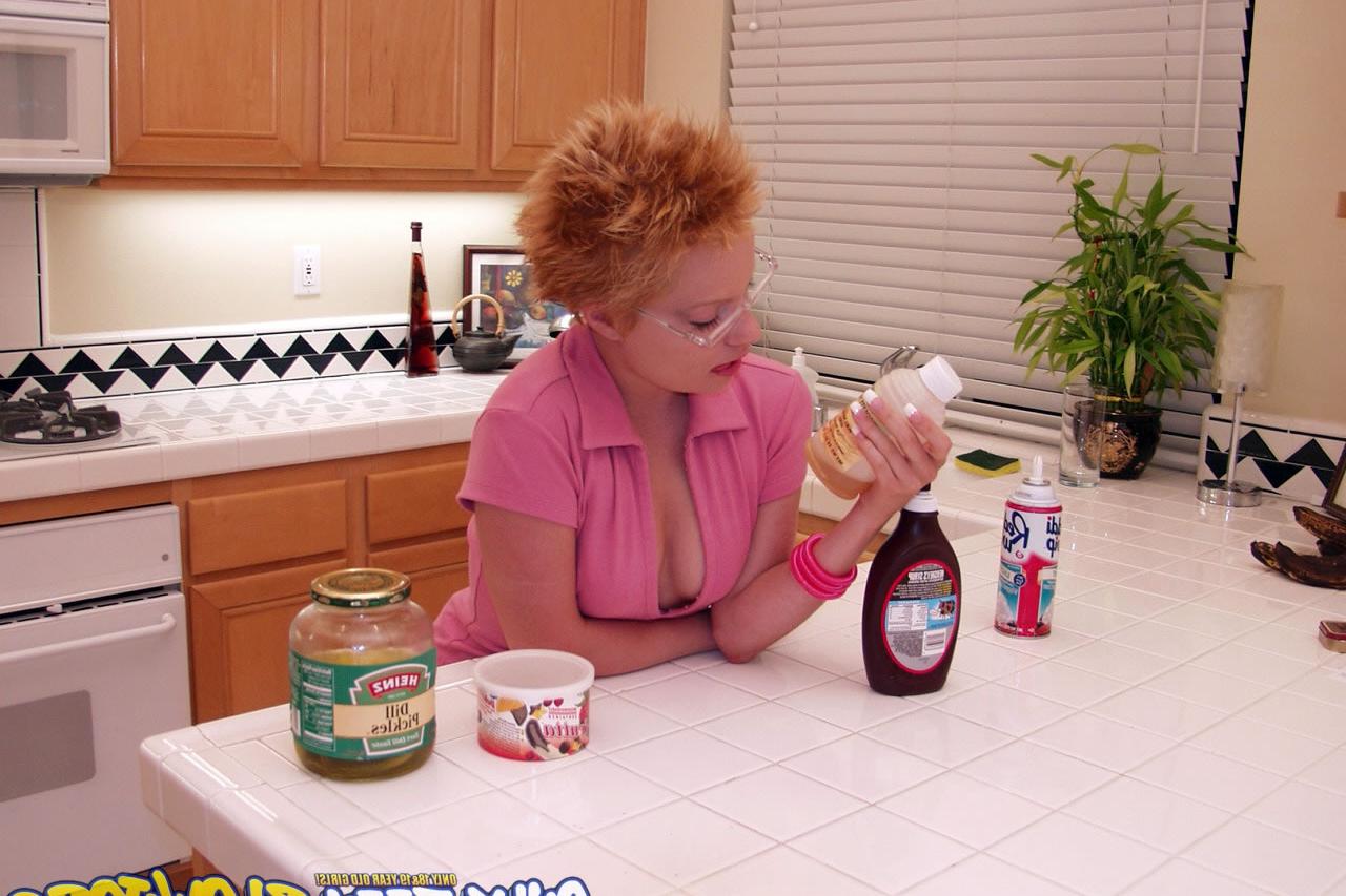 20P Naughty redhead Emily Davinci goes topless & indulges in a food play solo