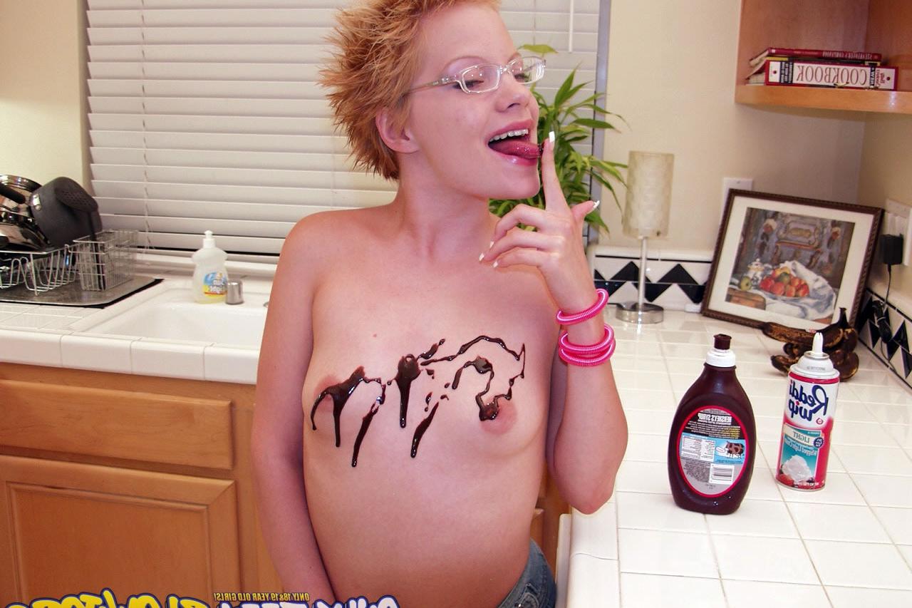 20P Naughty redhead Emily Davinci goes topless & indulges in a food play solo