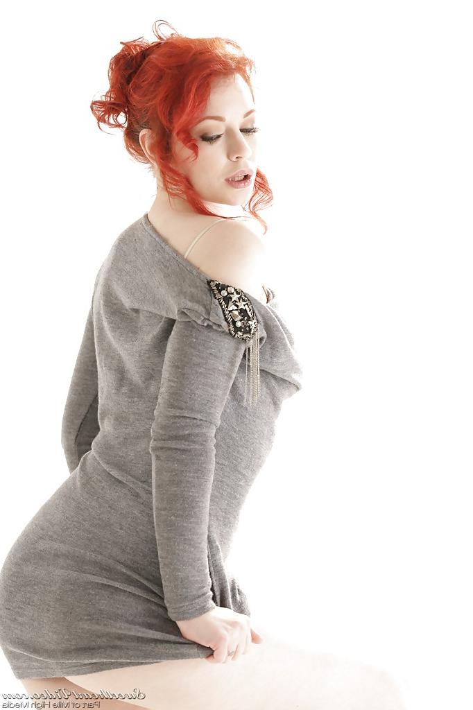 16P Clothed redhead Justine Jolie reveals her milf ass in a skirt