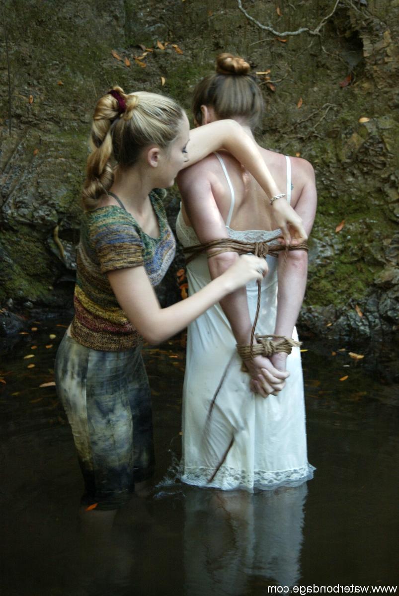 20P Busty virgin gets schooled by a blonde lezdom in outdoor water bondage action