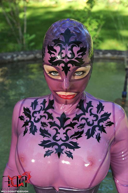 16P British solo girl Latex Lucy models latex clothing near a pond