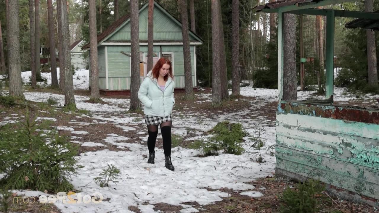 15P Redheaded girl Nikky B takes a piss on a chilly day upon outdoor stairs