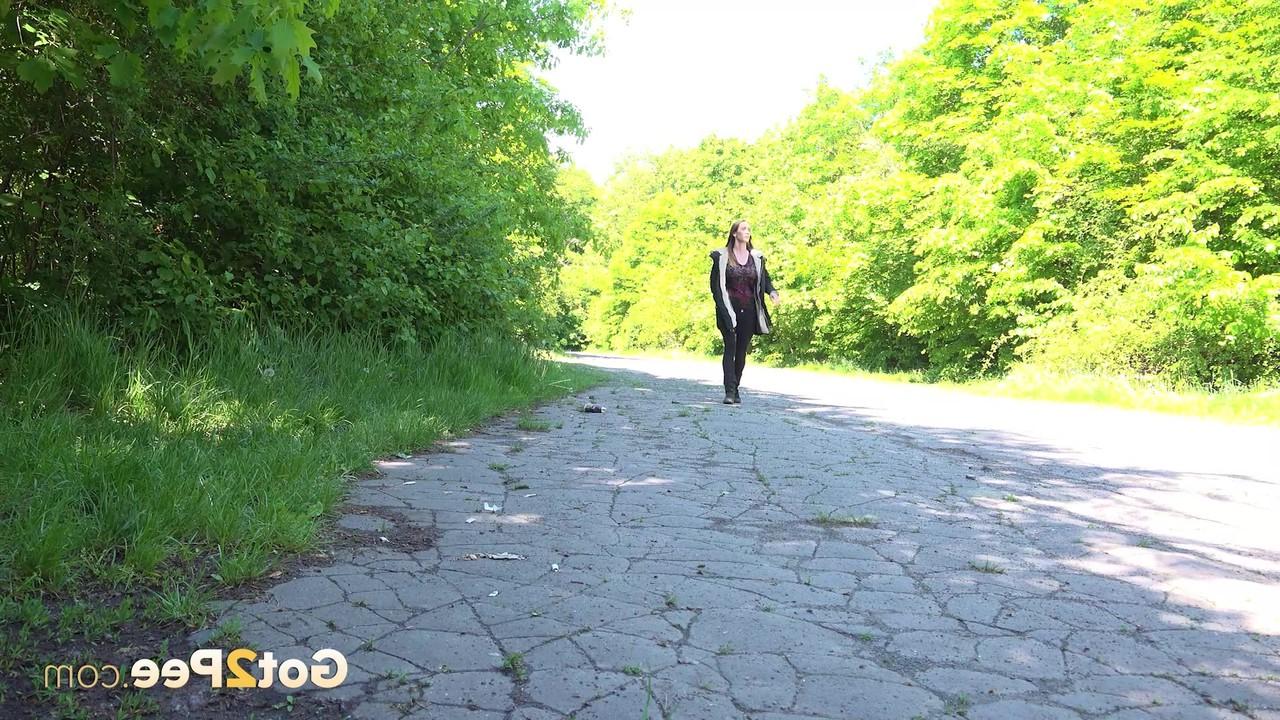15P Caucasian female Cynthia Vellons takes a piss on a paved road in suede boots
