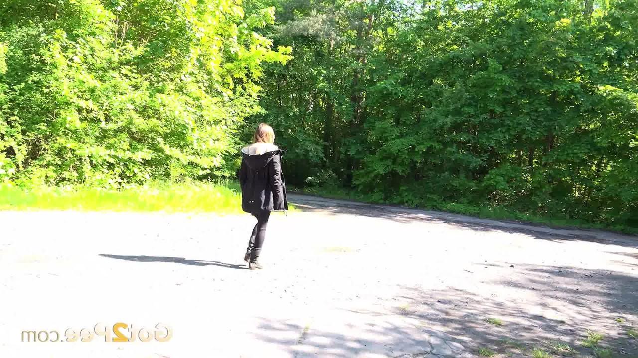 15P Caucasian female Cynthia Vellons takes a piss on a paved road in suede boots
