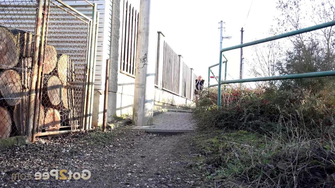 15P La blonde Daisy Lee s'accroupit pour pisser dans une ruelle.