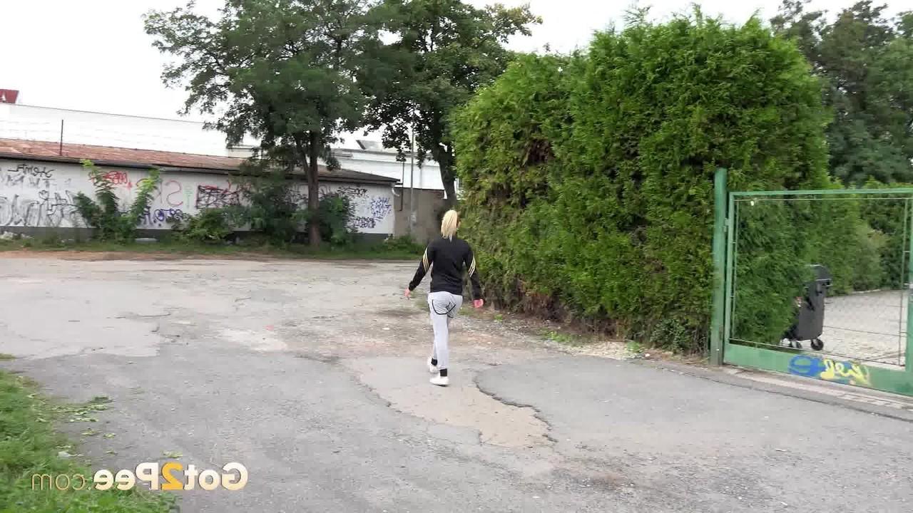 15P Blonde girl Debora squats for a piss while taking a walk in the city