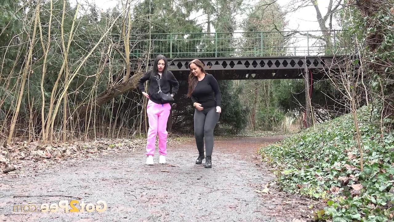15P Selena and her girlfriend both squat to take a piss on a rural path