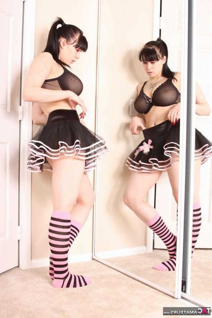 20P Busty amateur Susy Rocks models non nude afore mirror in skirt and socks