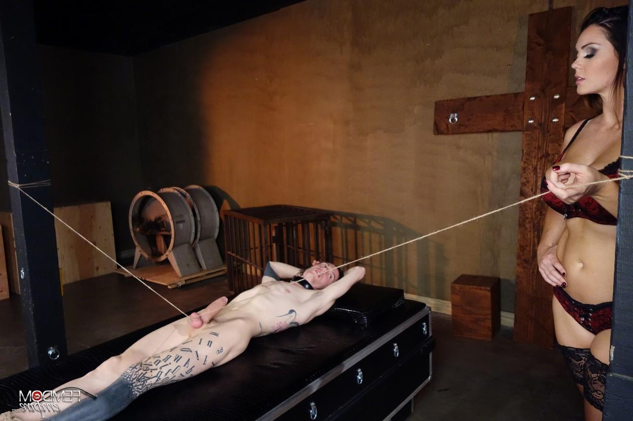 16P Mistress Alison Tyler jerks on a restrained man's penis in a dungeon