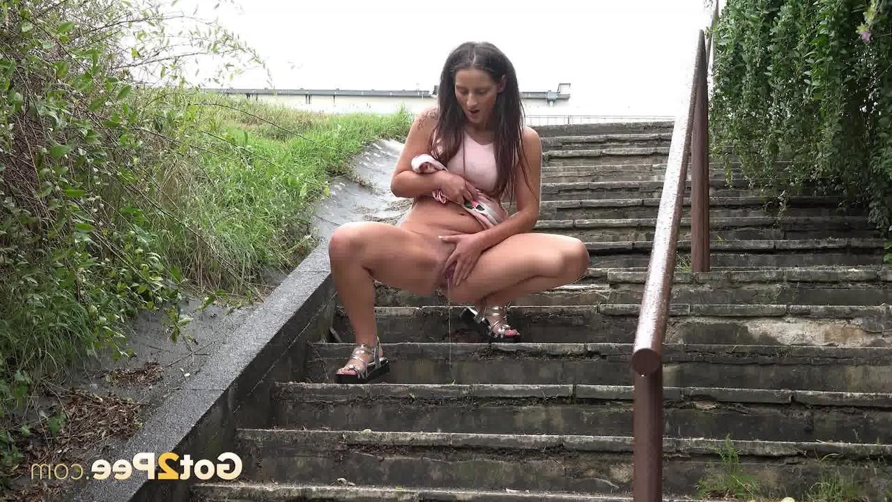 15P Nicolette Noir pauses to piss on a riverbank and a flight of concrete steps