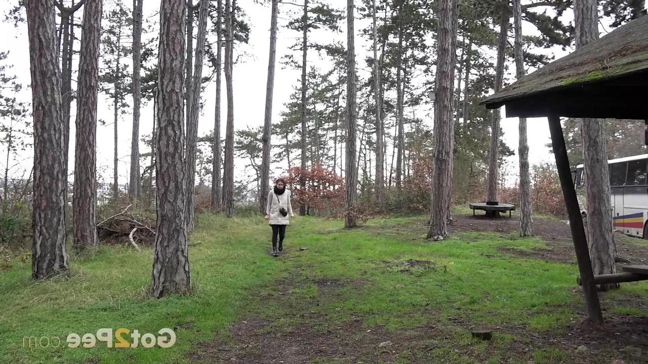 15P Brunette girl Lara Fox squats under a shelter to take a badly needed pee