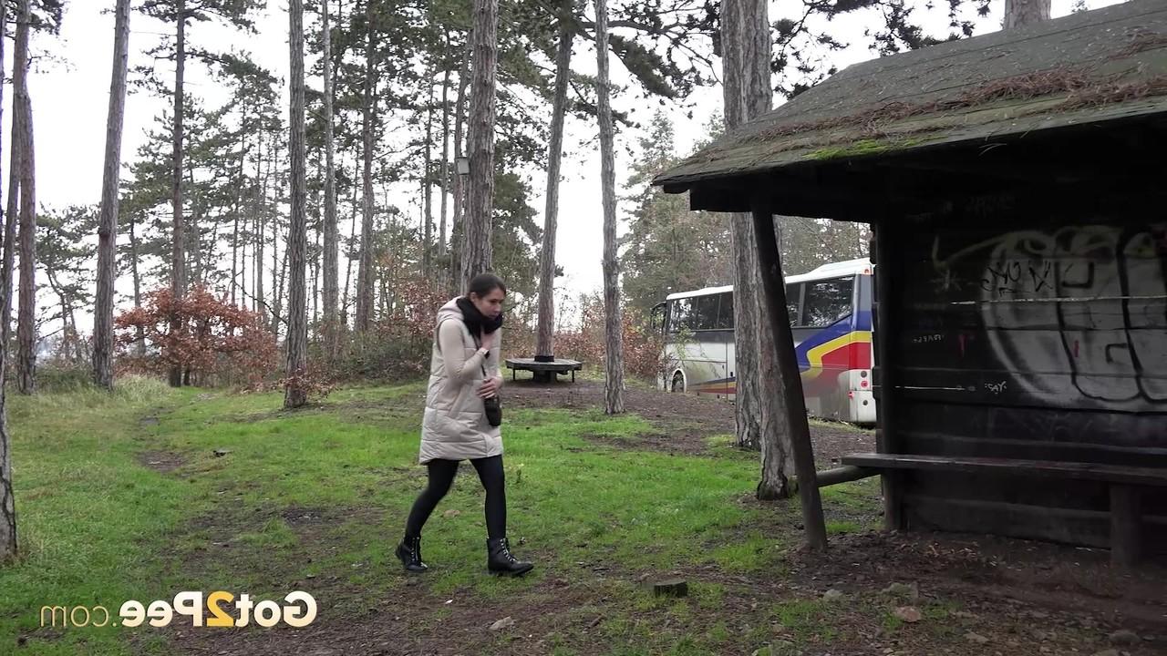 15P Brunette girl Lara Fox squats under a shelter to take a badly needed pee
