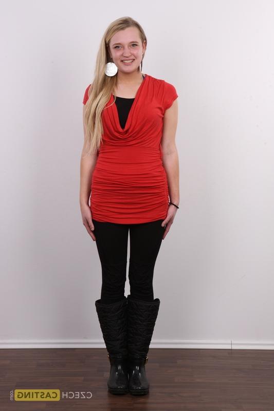 20P Blonde amateur Lucie stands fully clothed before getting entirely naked