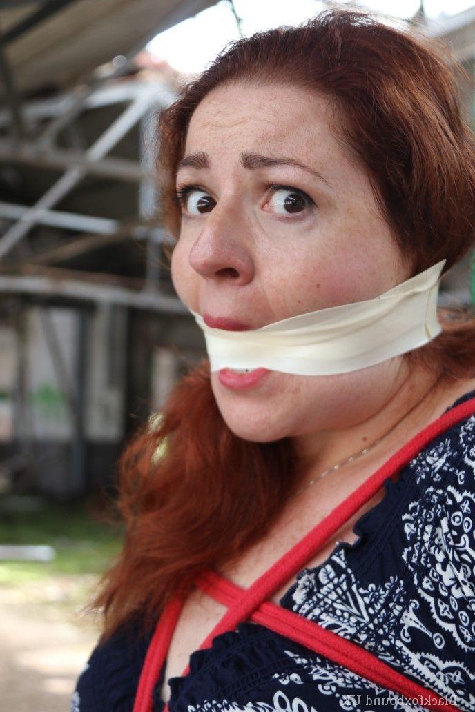 16P Redhead BBW finds herself gagged & tied to a post while clothed in a warehouse