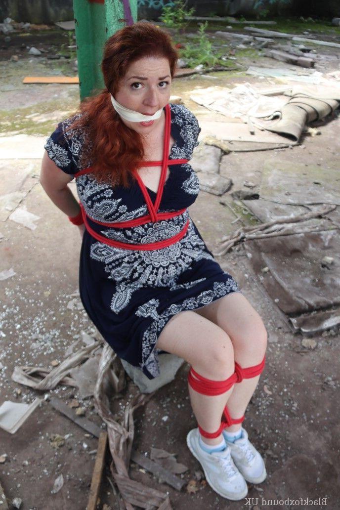 16P Redhead BBW finds herself gagged & tied to a post while clothed in a warehouse