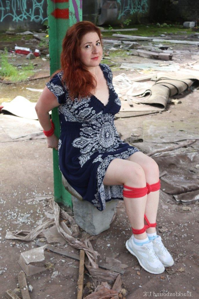 16P Redhead BBW finds herself gagged & tied to a post while clothed in a warehouse