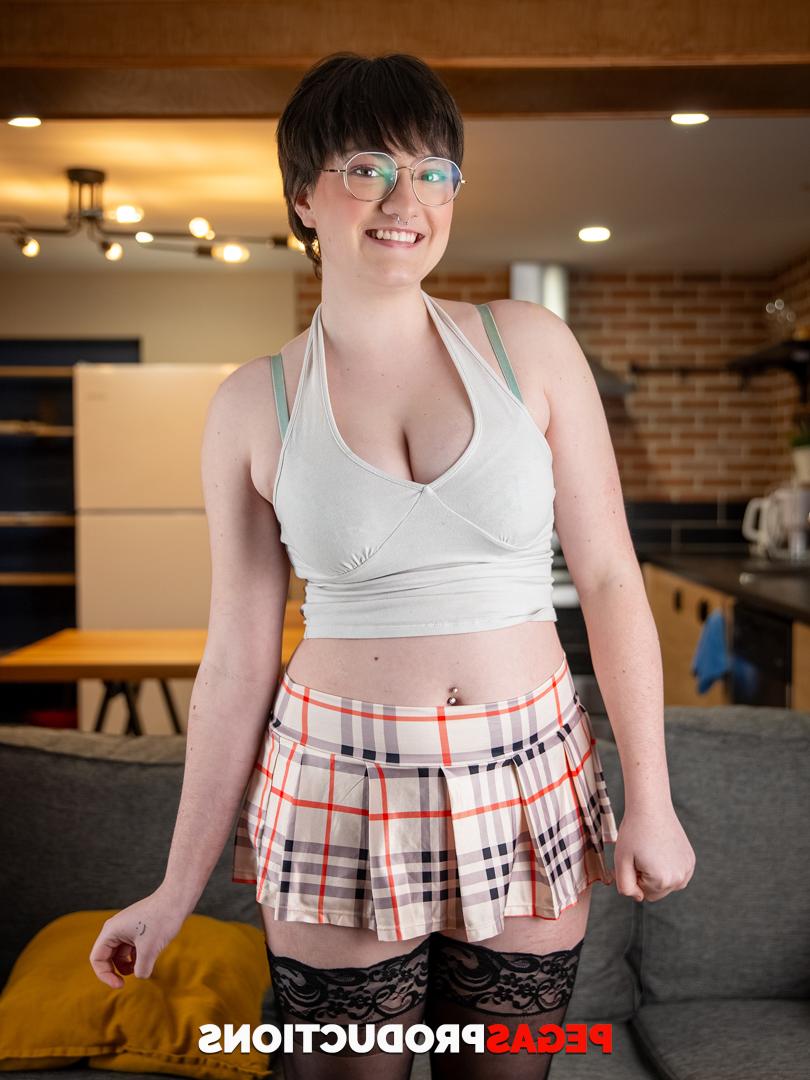 20P Short haired teen in glasses Kitty Kunt displays her big tits and bubble ass